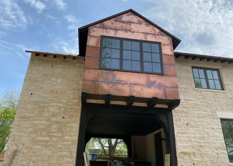 Copper metal panel facade on a stone building for Roof Repair in Arcadia