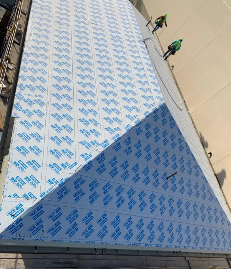 Professional roofers installing underlayment on a metal roof in Arcadia